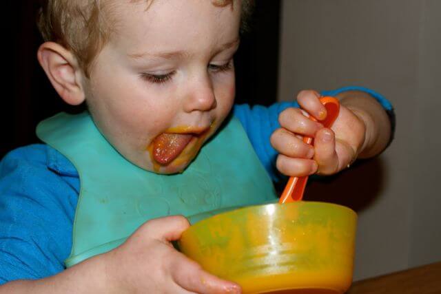Toddler Eating Carrot and Orange Soup