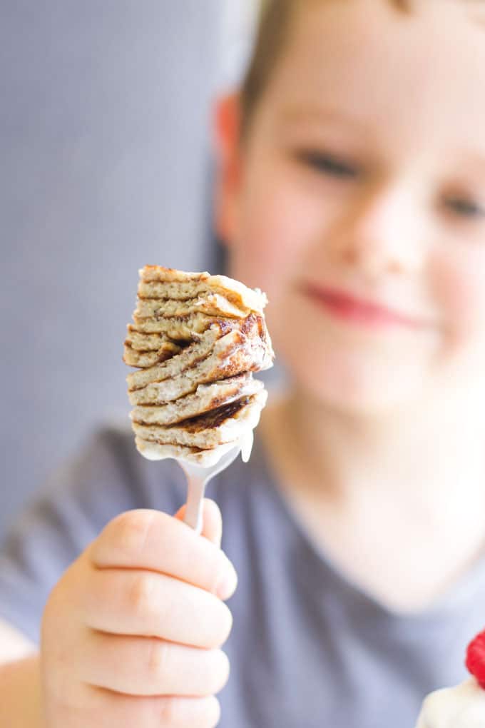 Child Holding 2 Ingredient Banana Pancakes Cut and Stacked on Fork