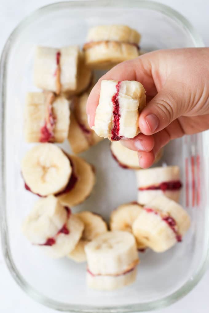 Child Holding Frozen Banana Treat with Bite Out