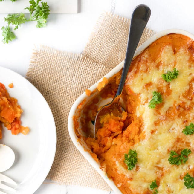 Cooked Lentil Shepherd's Pie in Dish with Spoonful Remove and Plated.