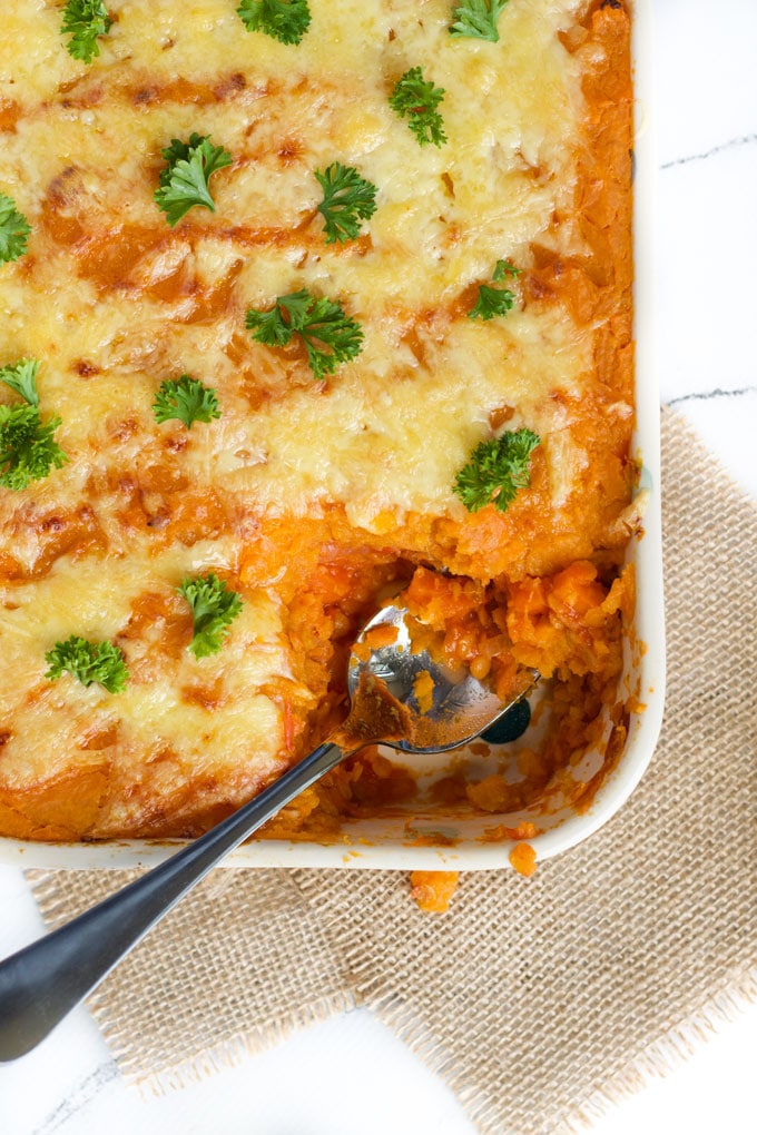 Cooked Lentil Shepherd's Pie in Dish with Spoonful Removed