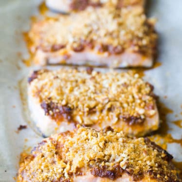 Baked salmon fillets with a sundried tomato crust on a baking tray