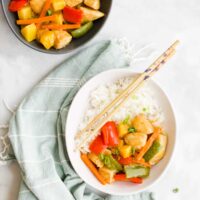 Top Down View of Two Bowls of Sweet and Sour Chicken with Rice