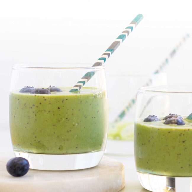 Side on shot of Green Smoothie in Glass with Straw