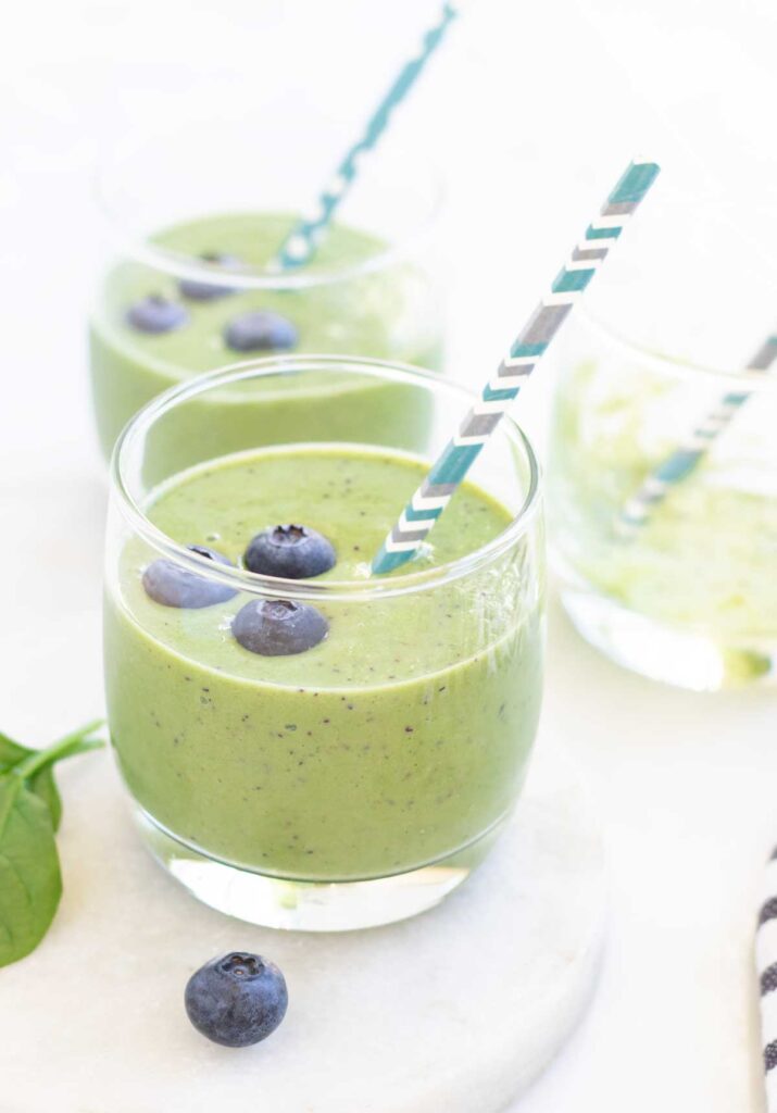 Two Green Smoothies in Glasses and Straws