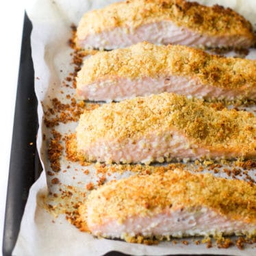 Freshly cooked parmesan crusted salmon fillets on baking tray
