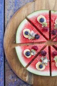 watermelon pizza is a refreshing, fun and healthy snack / dessert for kids. Let kids choose their toppings.