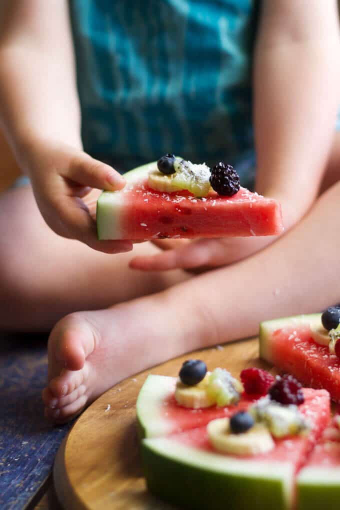 watermelon pizza is a refreshing, fun and healthy snack / dessert for kids. Let kids choose their toppings.