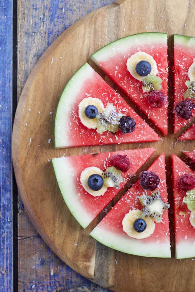 watermelon pizza is a refreshing, fun and healthy snack / dessert for kids. Let kids choose their toppings.