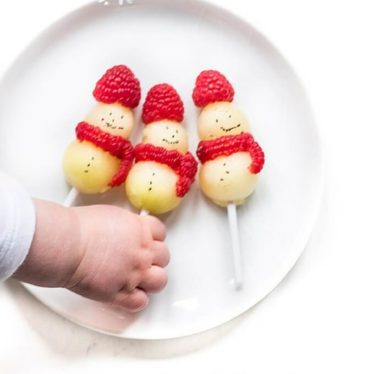 Melon snowmen with a raspberry hat and scarf