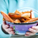 Child Holding Bowl of Sweet Potato Wedges