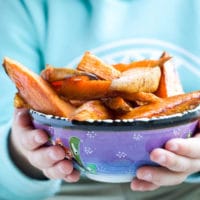 Child Holding Bowl of Sweet Potato Wedges