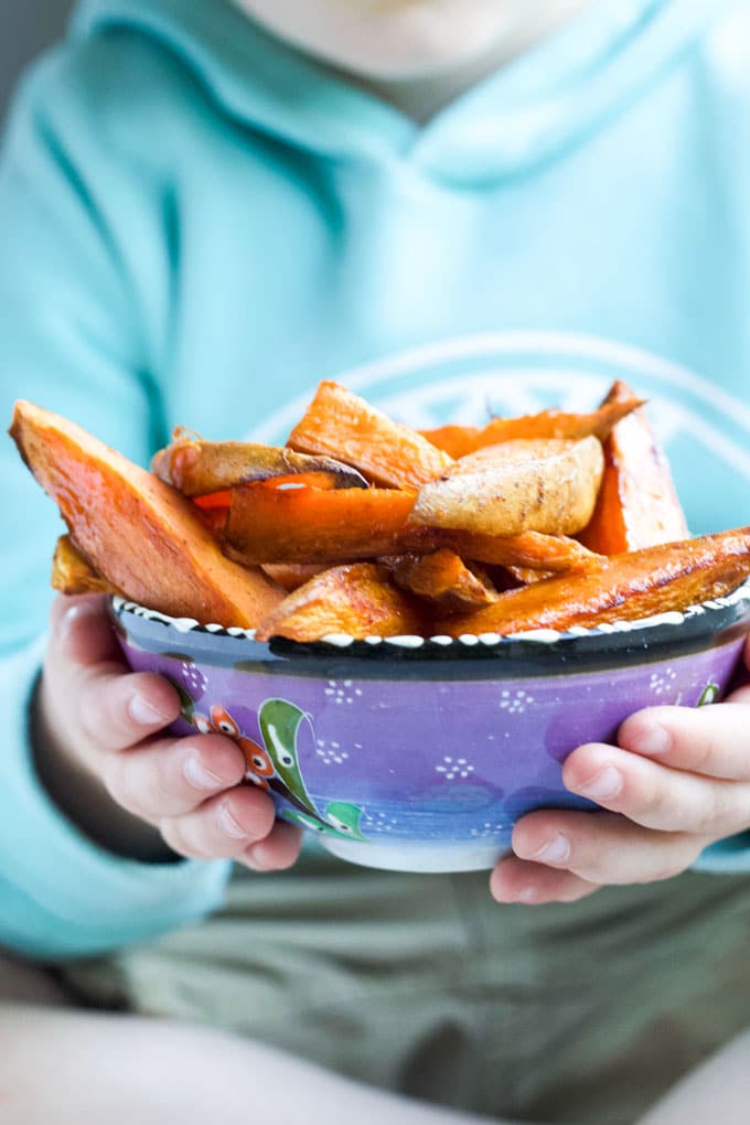 Child Holding Bowl of Sweet Potato Wedges