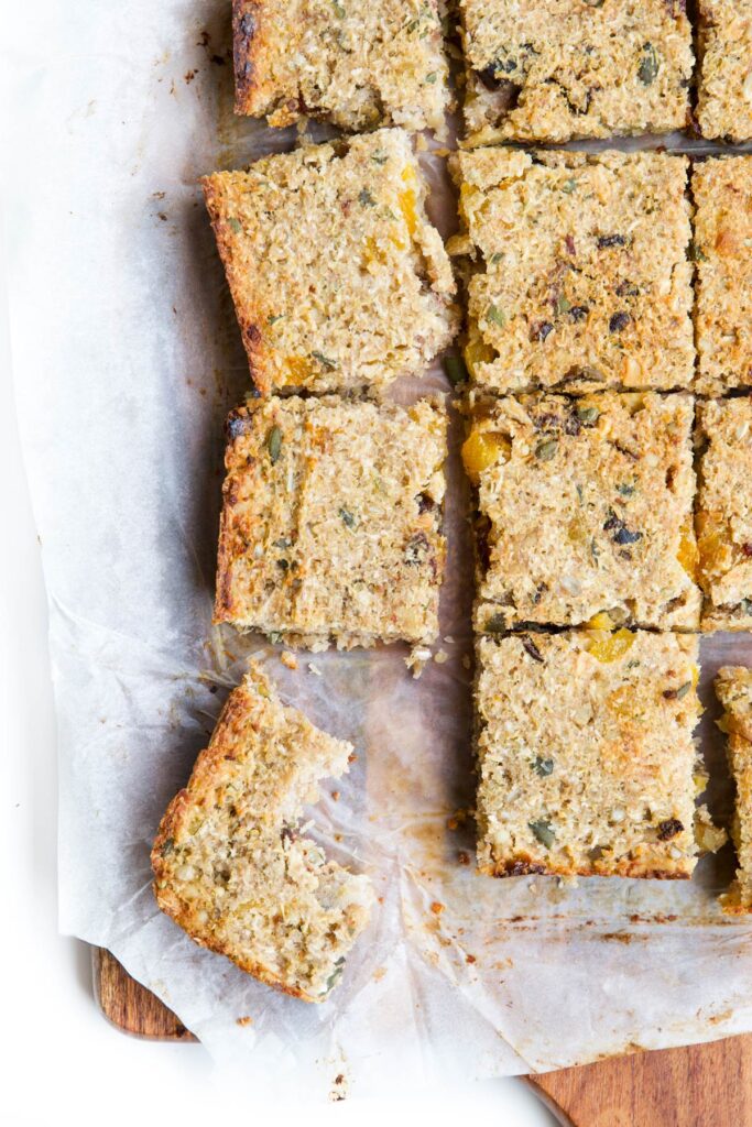 Top Down View of Quinoa Bars Cut into Square. One moved to Side with Bite Removed