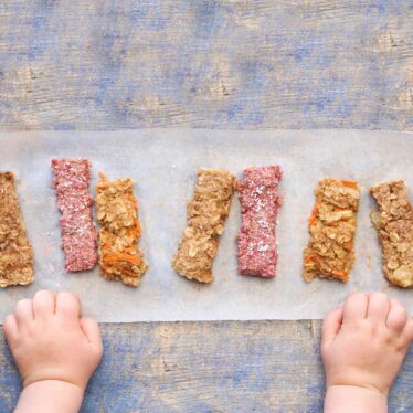 Top down View of Row of Porridge Fingers with Baby Hands Next to Them