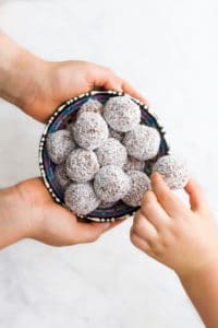 Child Grabbing a Sweet Potato Truffle from Bowl