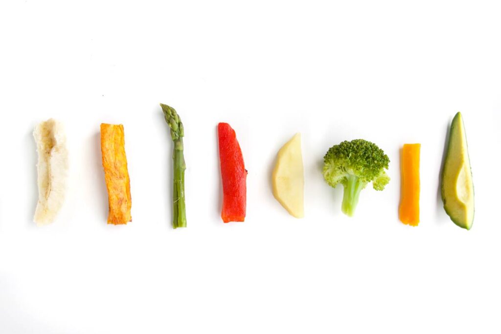 One Row of Fruit and Vegetables Cut into Fingers for Baby Led Weaning (Banana, Sweet Potato, Asparagus, Bell Pepper, Apple, Broccoli, Carrot and Avocado)