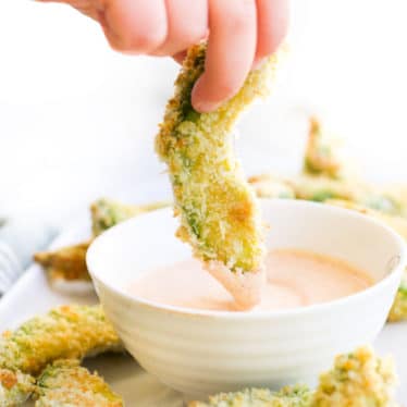 Child Dipping Avocado Fries into a Dip