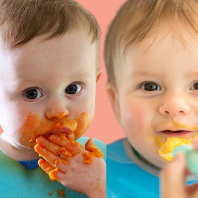 Two Babies Side By Side. One Eating Using His Hands The Other Being Spoon Fed.