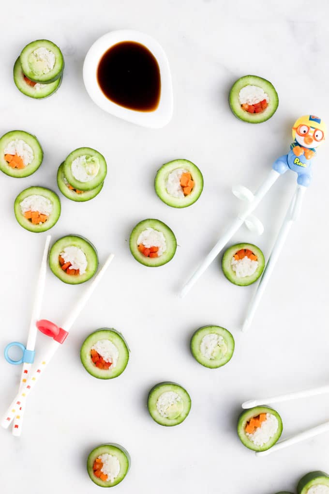 Cucumber Sushi on Board with Kids Chop Sticks and Soy Sauce Dip