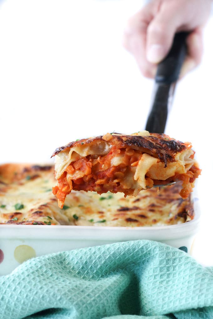 Portion of Red Lentil Lasagne being Lifted from Baking Dish