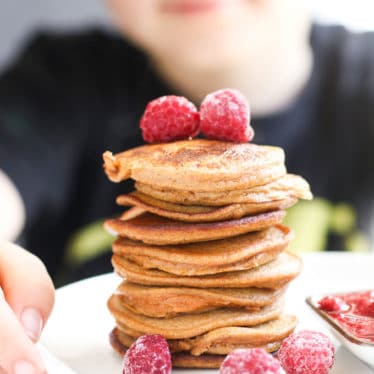 Child Looking at a Stack of 2 Ingredient Sweet Potato Pancakes