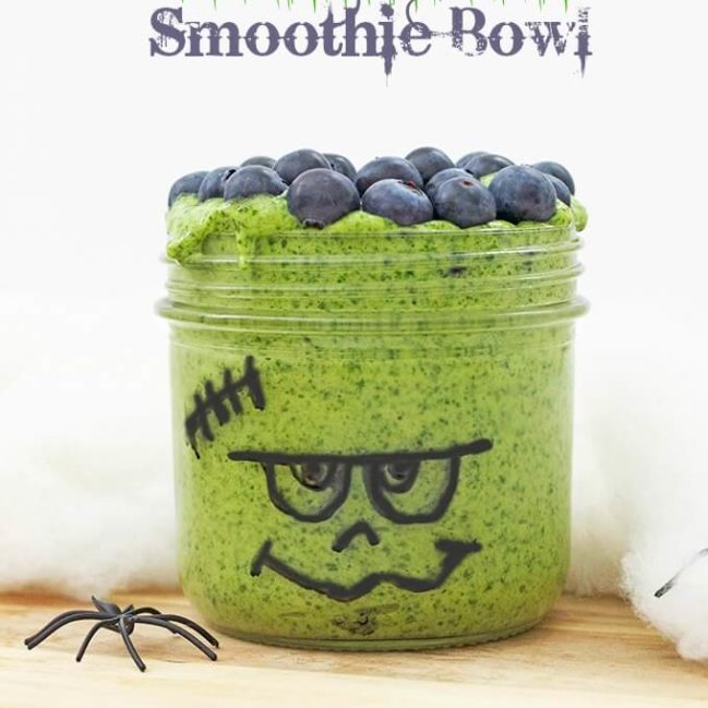 Frankenstein Smoothie Bowl (healthier halloween snacks for kids) Spinach, banana and mango blended together and topped with blueberries