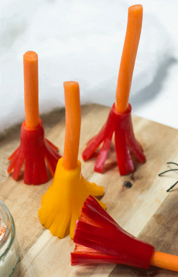 Witches broomsticks healthy halloween snack for kids. Made from carrot and peppers your kids will love dipping them into their favourite dip