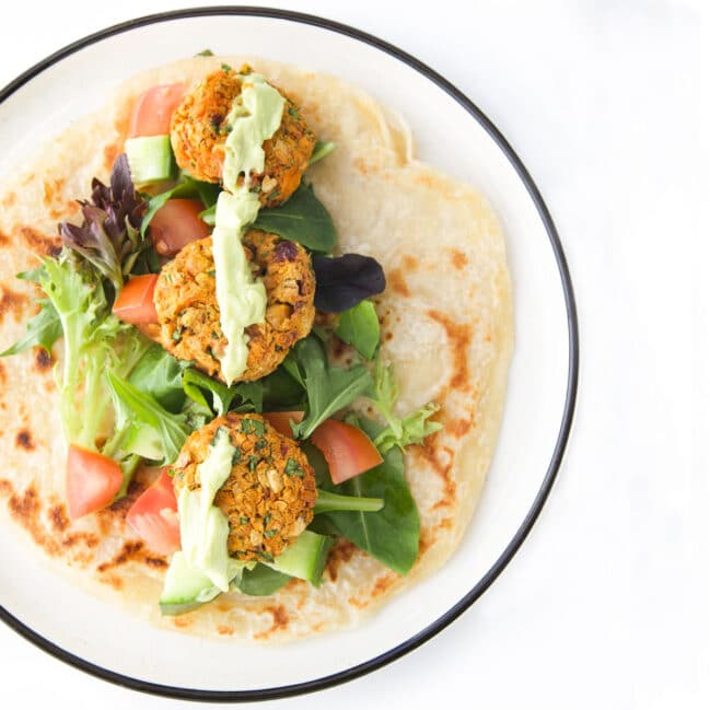 Sweet Potato Chickpea Patties on Wrap with Salad and Avocado Sauce.