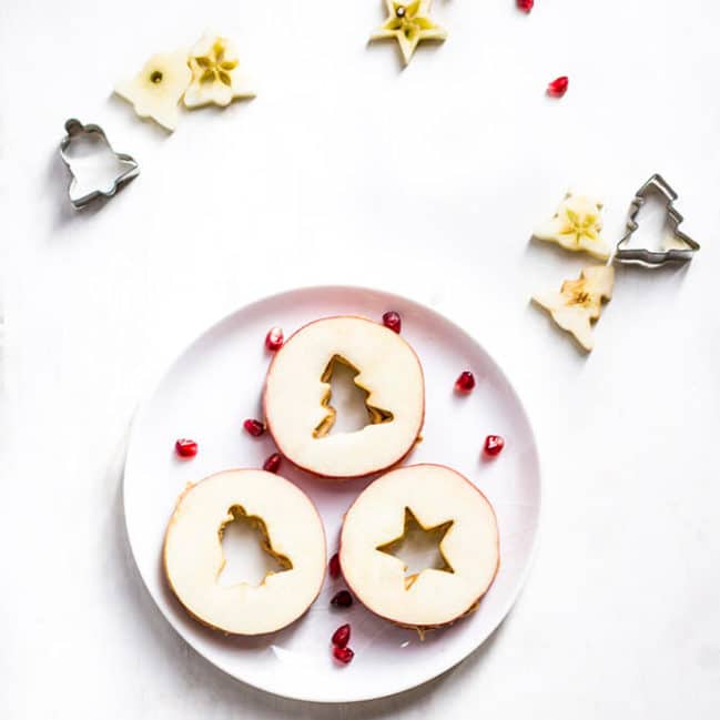 Apple and peanut butter Christmas Sandwiches made from two slices of apple filled with peanut butter.