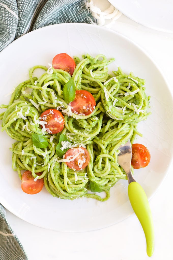 Plate of Avocado Spinach Spaghetti Topped with Cherry Tomato