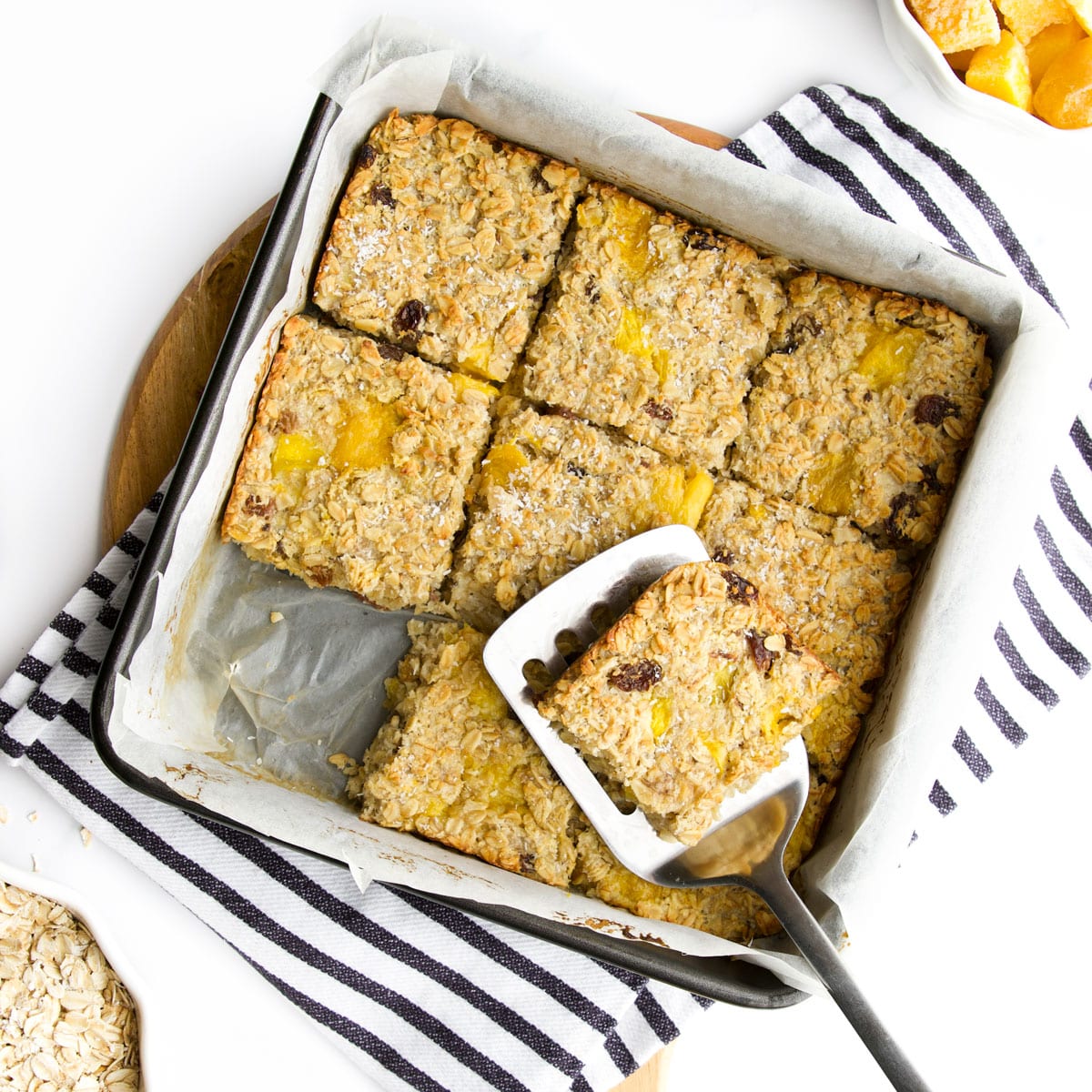 Baked Mango Oatmeal Cut Into Squares in Pan.