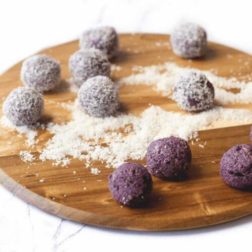 45 Degree Shot of Blueberry Balls on Wooden Board. Some Balls Coated in Coconut and Others Un Coated