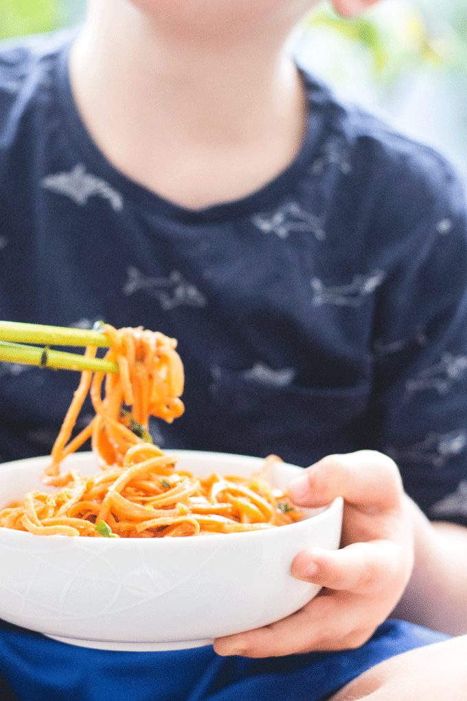 These Asian style sweet potato noodles are sure to be loved by the whole family. Sweet potato are spiralized and cooked in an asian style peanut sauce. Kid Friendly
