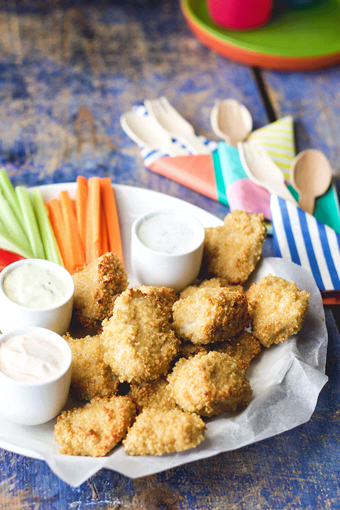Close Up Side View of Quinoa Crusted Chicken Nuggets on Plate with Dips