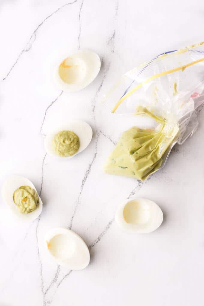 Healthy avocado fat and high protein eggs make these avocado devilled eggs a super healthy breakfast, lunch or snack. Quick to make & mayo free.