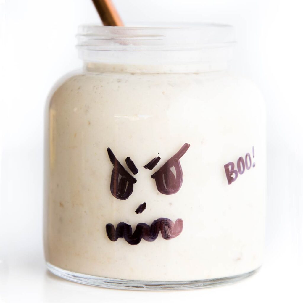 Ghost Smoothie (Glass Jar with Ghost Face Drawn on Filled with a White Smoothie)