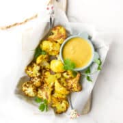 Top Down Image of Turmeric Cauliflower in Dish with Mango Dip.