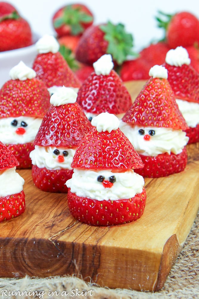 Strawberry Santas, made from Strawberries and Whipped Cream Cheese, Sitting on Wooden Chopping Board