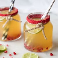 Mocktail served in glass jar with pomegranate and lime