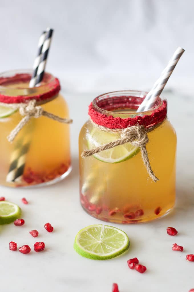 Mocktail served in glass jar with pomegranate and lime
