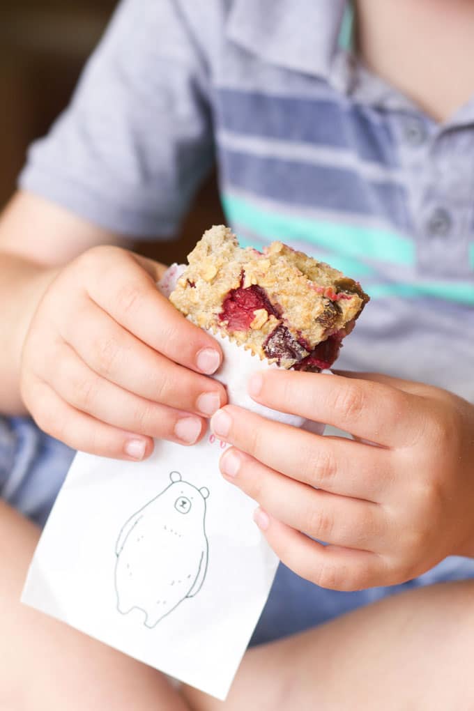 baked oats on the go. Child eating sliced baked oats in a paper bag.