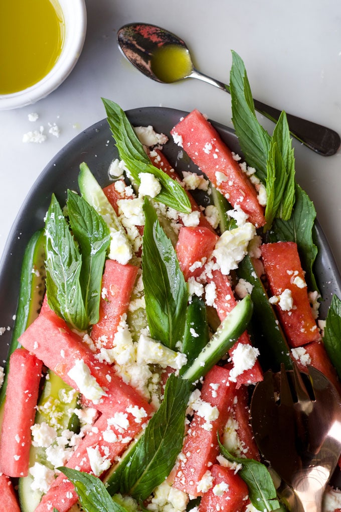 Plate of watermelon feta mint salad with dressing on the side