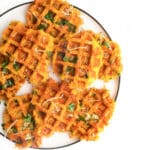 Savoury Waffles On Plate Sprinkled with Grated Cheese and Chopped Parsley.