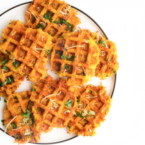 Savoury Waffles On Plate Sprinkled with Grated Cheese and Chopped Parsley.