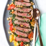 Striploin Steak Served on a Bed of Kale, Pepper and Chickpeas.