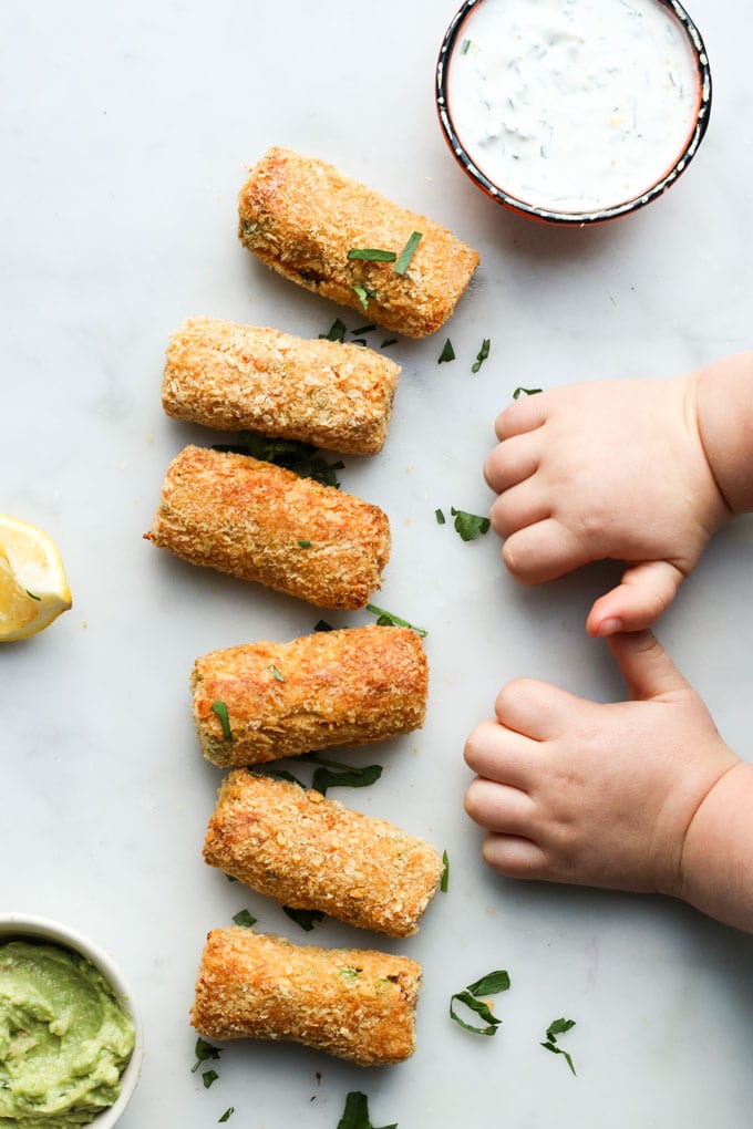 Toddler Hands Next to Line of Salmon Croquettes