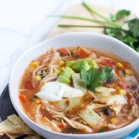 Bowl of Slow Cooker Chicken Tortilla Soup Topped with Avocado and Yoghurt
