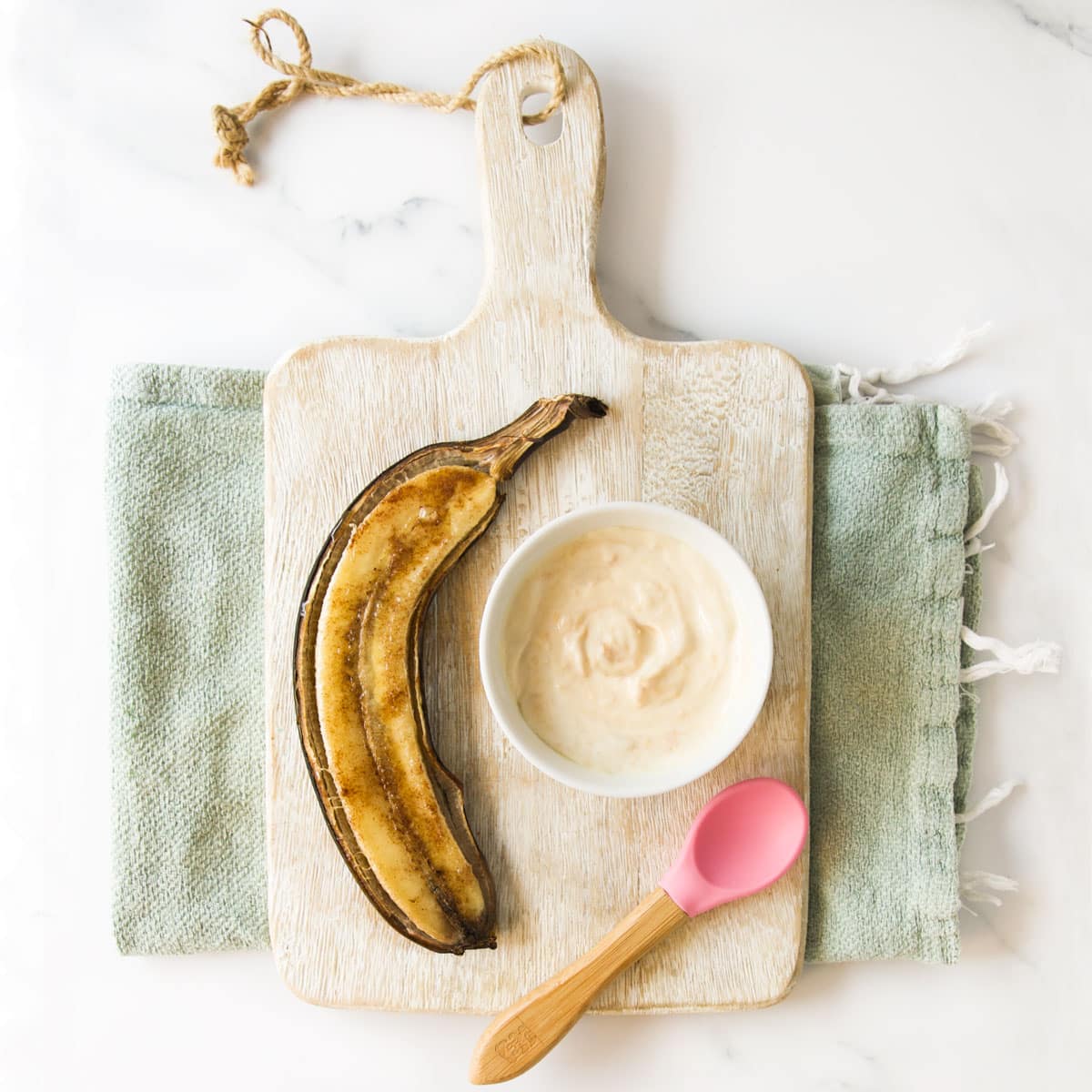 Baked Banana On Board with Baby Spoon and Dip.