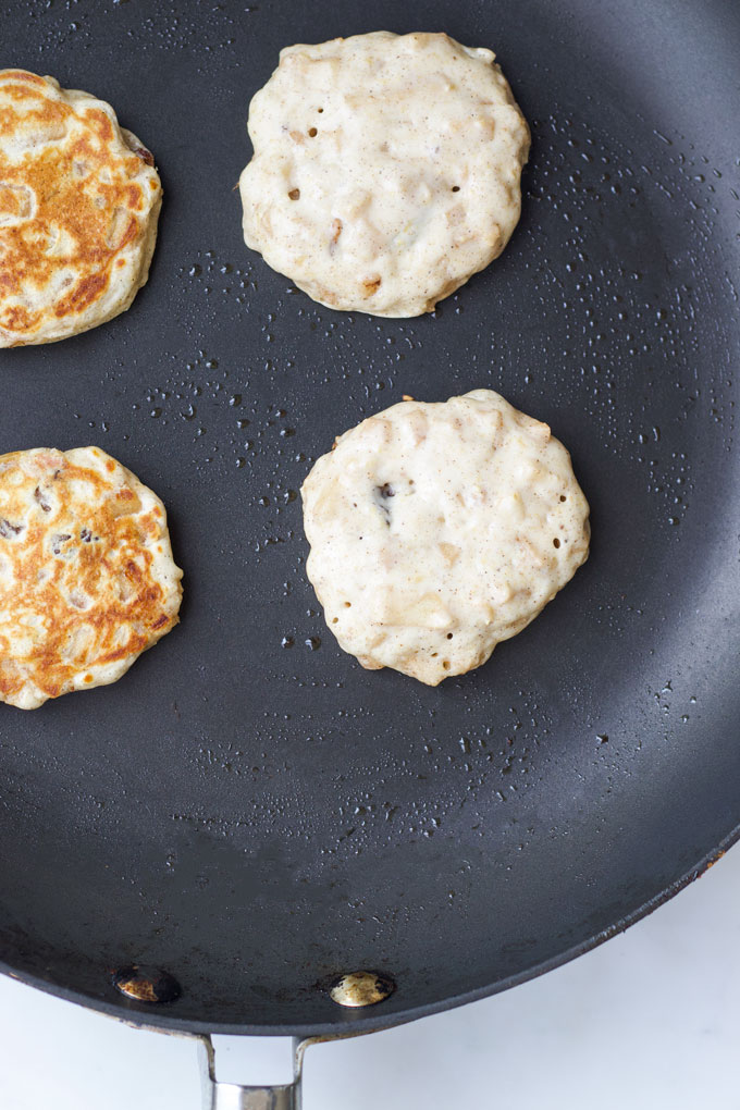 Apple Pancakes in Pan Before and After Flipping